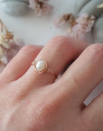 Minimalist 14k rose gold filled pearl wire wrapped ring worn on a model’s hand