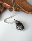 Handcrafted apache tears obsidian necklace on chain, laying flat – artisan white gold copper wire wrapping, natural volcanic glass, for all genders, Designs by Nature Gems.