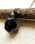 Back view of men's apache tears obsidian necklace – natural volcanic glass, detailed wire wrapping, white gold and black copper, Designs by Nature Gems.
