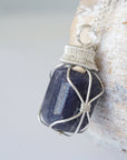 Left angle close-up of sapphire necklace for men – highlighting unique wire-wrapped artistry, blue sapphire, 925 sterling silver.
