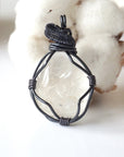 Front angle close-up of clear quartz pendant – detailed gunmetal copper wire wrapping, natural crystal, April birthstone.