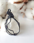 Right angle close-up of clear quartz pendant – showcasing artisan wire wrapped gunmetal copper, natural crystal.