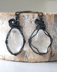Two clear quartz pendants for men – showing natural variation in size, shape, gunmetal copper wire wrapping.