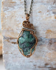 Handcrafted raw emerald necklace front view – artisan bronze and silver copper wire wrapping, May birthstone jewelry for all genders, Designs by Nature Gems.