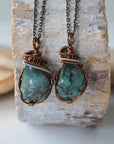 Two raw emerald pendants – displaying unique differences in natural emerald crystals, wire-wrapped for all genders.