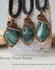 Three raw emerald pendants for men – showing natural variation in size, shape, and green shade, black leather cord.