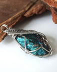 Right angle close-up of peacock ore pendant for men – showcasing artisan wire wrapped white gold copper, natural bornite crystal.