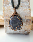 Handcrafted raw sapphire necklace for men, front view – artisan bronze copper wire wrapping, September birthstone, black leather cord.
