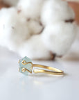 Left side angle of adjustable aquamarine ring, showing raw aquamarine and open band in 14k gold vermeil
