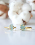Two adjustable aquamarine rings side by side, showing natural variation in aquamarine's size, shape, and color, 14k gold vermeil