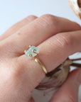 Adjustable aquamarine ring with raw gemstone in 14k gold vermeil prong setting on female model's hand, Designs by Nature Gems