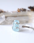 Left side angle of adjustable aquamarine ring, showing raw aquamarine and open band in 925 sterling silver