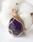 Front side angle of women’s amethyst necklace, polished dark amethyst, silver and gold plated copper wire wrap