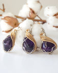 Three women’s amethyst pendants showing natural variation in stone size, shape, and color, silver and gold plated copper artisan wire wrap