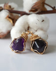 Two women’s gold amethyst necklaces showing natural variation in pendant size, shape, and color, artisan gold plated copper wire wrap
