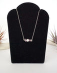 Amethyst and freshwater pearl bar necklace in 925 sterling silver on jewelry display, front view