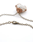 Close-up of antique bronze cable chain with lobster clasp closure on handmade rainbow moonstone necklace