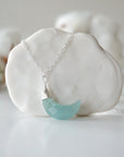 Detailed front view of aquamarine moon necklace for women, minimalist artisan wire wrapping in sterling silver, Designs by Nature Gems