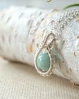 Left side angle of aquamarine necklace for women, detailed wire wrapping, soft silver finish