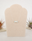 Aquamarine and freshwater pearl bar necklace in 925 sterling silver on jewelry display, front view