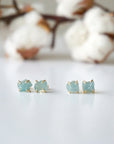 Two pairs of raw aquamarine stud earrings showing natural variation in size, shape, and blue color, Designs by Nature Gems