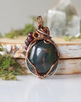 Detailed back view of a bloodstone pendant necklace showing secure handcrafted wire wrapping