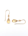 Closeup showing details of citrine drop earrings, faceted citrine stone, 14k gold filled setting