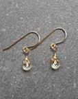 Close up detail of natural citrine crystal wire wrapped in 14k gold filled metal - handmade drop earrings showing artisan craftsmanship and golden stone