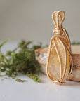 Side angle close-up of citrine pendant gold showing detailed wire wrapping craftsmanship November birthstone jewelry