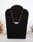 Clear quartz and freshwater pearl bar necklace in 925 sterling silver on jewelry display, front view
