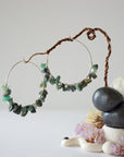Wire wrapped emerald hoop earrings in soft silver copper with natural emerald chips, detailed artisan jewelry view