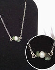 Close-up of raw emerald stones and freshwater pearl bar on 925 sterling silver necklace