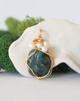 Detailed front angle of emerald and freshwater pearl pendant, gold wire wrapped, handcrafted gemstone jewelry