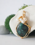 Side angle detail of emerald and freshwater pearl pendant, gold wire wrapped, ethical artisan necklace