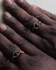 Gender neutral wire wrapped garnet ring shown on female and male hands to demonstrate fit and scale