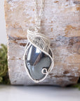 Front view of natural polished-raw hematite pendant necklace with detailed soft silver over copper wire wrapping