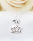 Detailed view of Herkimer diamond and lotus necklace in 925 sterling silver with natural raw crystal and symbolic lotus charm.
