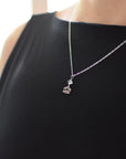 Herkimer diamond and lotus necklace in 925 sterling silver worn on a female model.