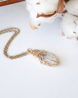 Raw Herkimer diamond pendant on gold plated brass chain with handmade warm gold copper wire wrapping.