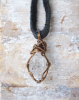 Back angle detail of raw Herkimer diamond pendant for men with intricate artisan wire wrapping in antique bronze copper.