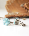 Side profile of men's aquamarine cufflinks, highlighting aquamarine stones and white gold finish copper setting