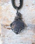 Back view of men's raw sapphire pendant showing the detail of antiqued 925 sterling silver wire-wrapping — one-of-a-kind handcrafted crystal jewelry