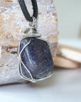 Right-angle detail of men's sapphire pendant showing artisan wire-wrapping in dark silver — handcrafted crystal necklace by Designs by Nature Gems