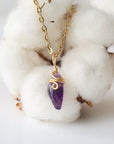 Back side angle of minimalist amethyst necklace, gold plated copper wire wrapped raw amethyst pendant