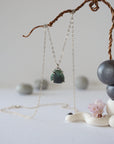 Zoomed out front view of minimalist emerald necklace in 925 sterling silver with natural emerald pendant.