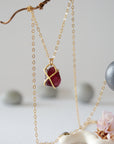 Back view of minimalist garnet pendant in 14k gold vermeil claw setting on a 14k gold filled chain