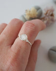 Minimalist rainbow moonstone ring for women in sterling silver wire wrap on hand, dainty June birthstone stacking ring.