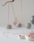 Back view of gold vermeil claw setting holding natural raw amethyst stone on minimalist February birthstone necklace