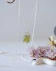 Side angle detail of minimalist raw peridot pendant — four-prong 925 sterling silver setting showing stone depth and natural texture, dainty August birthstone necklace for women