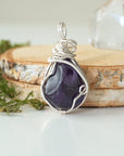 Back view detail of polished dark amethyst pendant necklace with sterling silver wire wrap